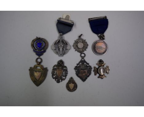 Seven various silver medals; together with another enamel example; and a further medal. (9)