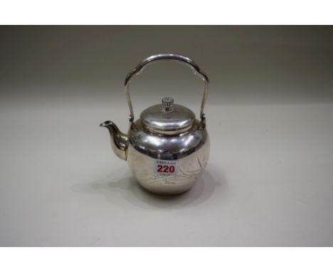 A Japanese metal tea pot, marks to underside and within lid, decorated chrysanthemum, prunus and bamboo, 18cm total height   