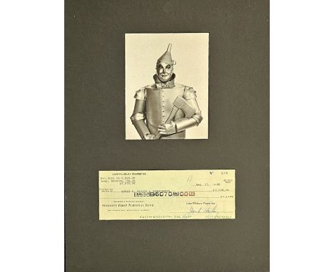 Jack Haley signed cheque mounted below black and white Tin man photo. Approx overall size 16x12inch. Good Condition. All auto