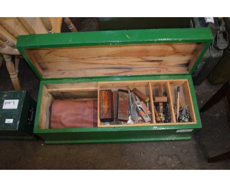 A wooden tool box and assorted contents