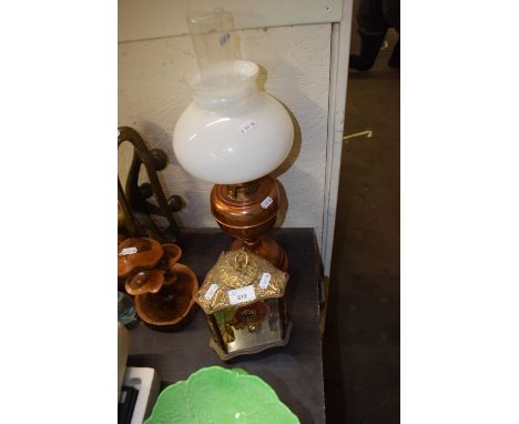 A 20th Century tortion mantel clock together with a copper based oil lamp