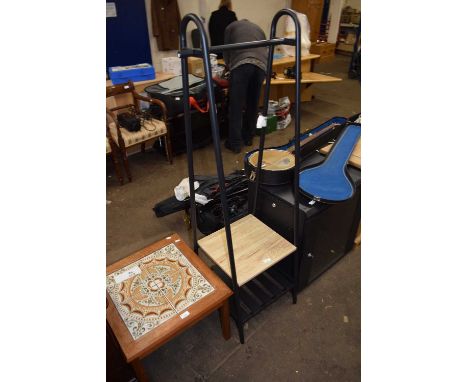 A modern metal framed clothes rail with shelf