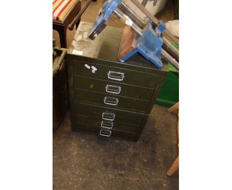Two sets of metal desk top filing cabinets and a bench vice