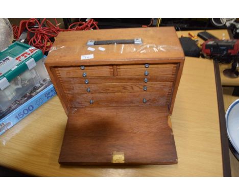A wooden tool box and assorted contents