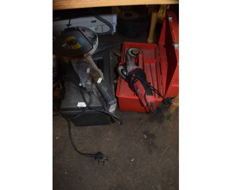 An angle grinder, further small disc cutter and two tool boxes with various contents