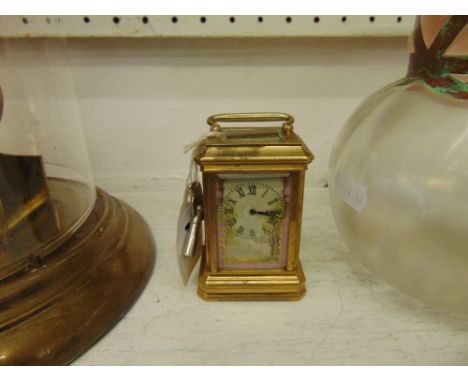 A miniature carriage clock, porcelain panel