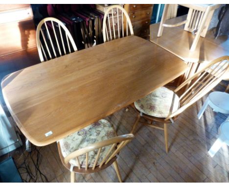 An Ercol light elm five piece dining suite Comprising refectory table, raised on inverted block supports, height 72cm, width 
