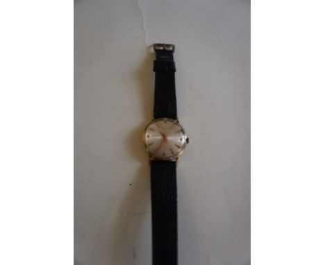Accurist: A 9ct gold manual wind wristwatchA.f., to black leather strap