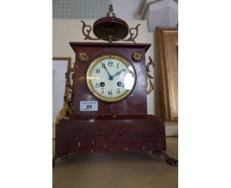 A circa 1900 French marble mantel clock having gilt applied decoration.
