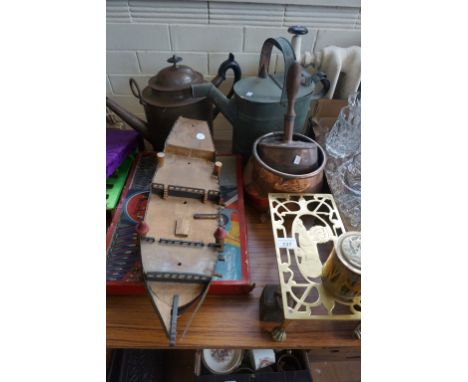 A mixed lot of assorted items to include a brass watering can, brass trivet, wooden model of a boat, a Chad Valley Regiment o