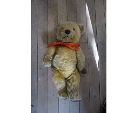 A Chiltern gold plush teddy bear, with glass button eyes, leatherette pads and articulated limbs, height 48cm.