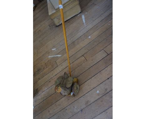 A vintage child's tin plate push along chicken.