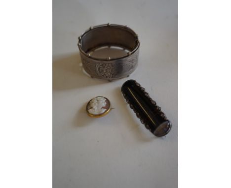 A Victorian white metal bangle Unmarked, with engraved decoration, together with, a cameo brooch, a banded agate brooch to wh