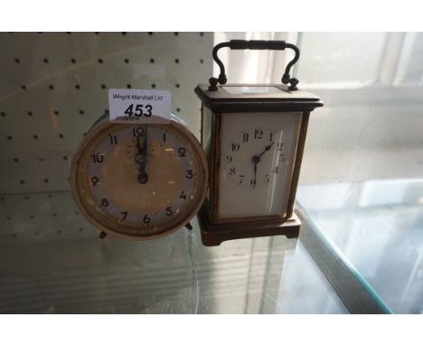 A brass four glass carriage clock together with a tin plate alarm clock.