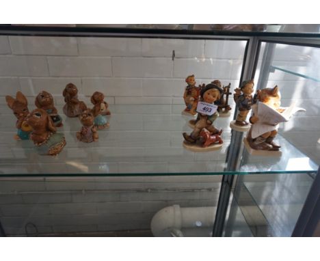 A collection of six Goebal & Hummel figurines to include a boy reading a newspaper, six Pendelfin figures (af)