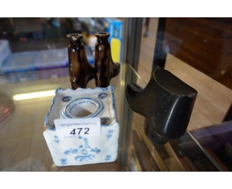 A pair of treacle glazed flasks in the form of boots, together with a Delft inkwell, and a slate model of a boot.