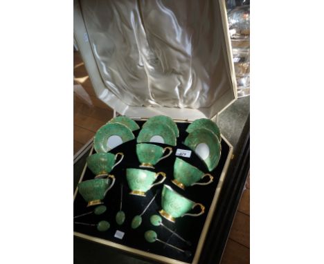 A Paragon china tea service having gilt scrolling decoration, with a green ground comprising six cups, six saucers, and six h