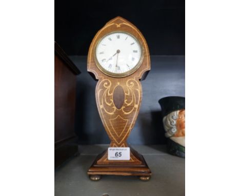 An Edwardian inlaid mahogany balloon mantel clock having Art Nouveau decoration.