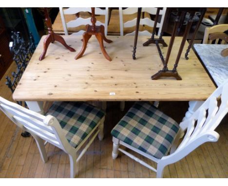 A good quality modern pine kitchen table of rectangular form together with four white painted ladder back chairs.