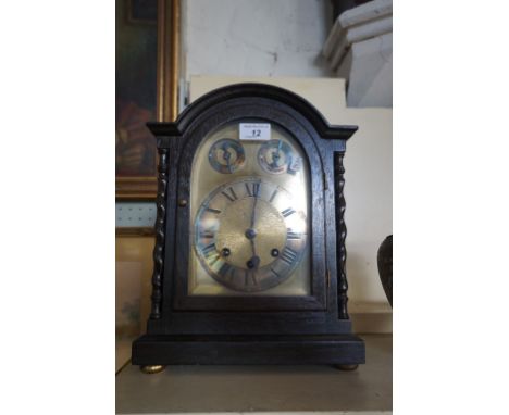 A 1920/30s dark oak bracket clock.