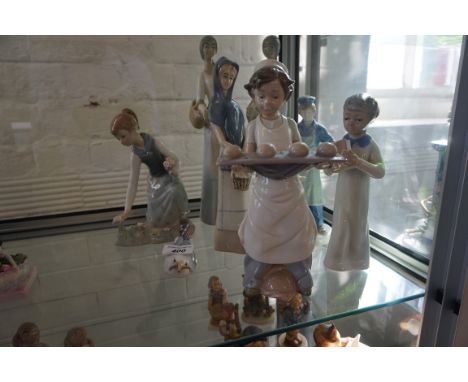 A collection of Lladro, Nao, Bing & Grondahl figures, to include a baker boy, a girl picking flowers etc.