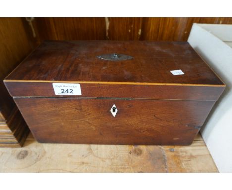 A Victorian mahogany tea caddy, the hinged cover enclosing two fitted compartments.