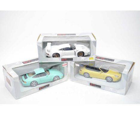 A collection of UT Models 1:18 scale diecast model cars, comprising: Porsche 911 GT1; Porsche 911 Cabrio; and a Porsche 911 C