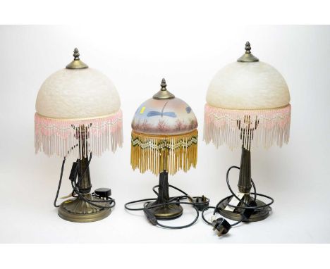 A pair of Art Deco style table lamps, each with pale pink mottled glass shade with beaded tassel border, 52cms high (one marg