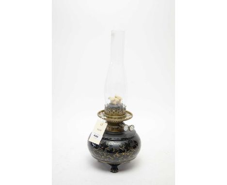 A Hinks’s Duplex enamelled glass oil lamp, the body decorated with gilt vines, raised on three paw feet, 44cms high including
