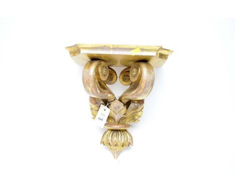 A Continental gilt wall sconce, with shaped shelf over scrolls and foliate wall mount, 33cms high.