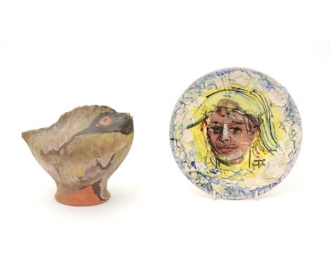 A continental terra-cotta bird sculpture indistinctly signed H Agarie, 22.5cms; and an Italian ceramic plate decorated with a