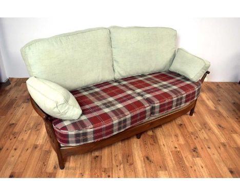 A 20th Century Ercol Renaissance range living room suite, comprising of a sofa and swivel chair, the suite upholstered in pal