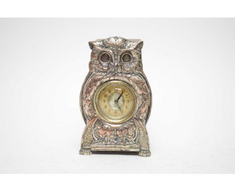 A 1930s silver plated owl mantel clock, formed as an owl, cream enamel dial with Arabic numerals in black, 17cms high. 
