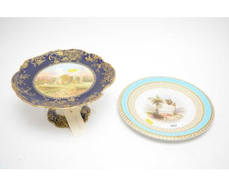 A ‘Furness Abbey’ pedestal cake plate, hand painted with abbey landscape, signed J. R. Keeling, within rich blue and gilt bor