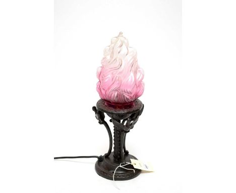 A bronzed table lamp, with Art Deco style ombré glass flame motif shade, over a circular bowl raised on flame motif pillar an
