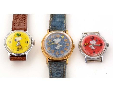 Three Snoopy United Feature Syndicate manual wind wristwatches, two with Snoopy playing tennis dated 1958, and one with Woods