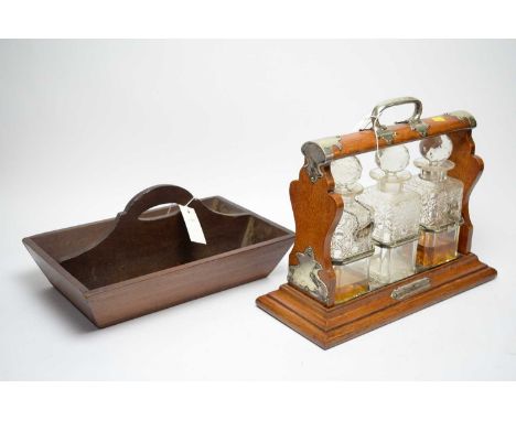 A Victorian mahogany three bottle tantalus, with silver plated mounts, by Walker &amp; Hall, Sheffield, fitted with three cut
