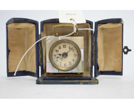 An early 20th Century bedside travel clock, of square section, with mother of pearl decoration to the case, in a fitted trave