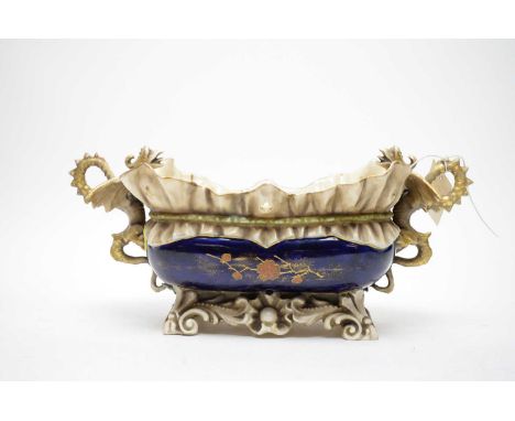 An Austrian ceramic jardiniere or planter, with twin dragon handles, numerical marks to underside, 39cms wide.