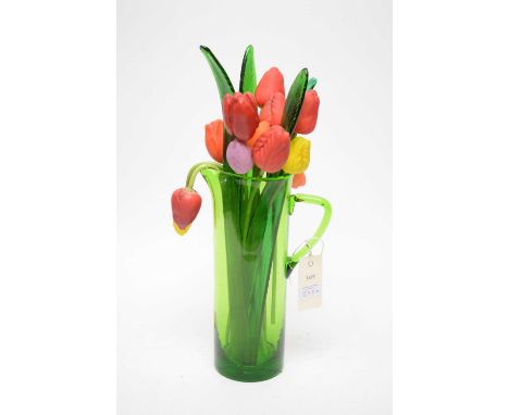 A bunch of art glass tulips, in red, orange, yellow and lilac, matte finish, with four green glass leaves, contained together