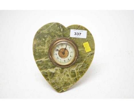 A 19th Century onyx and gilt metal heart-shaped mantel clock, with picture easel back, 15cms high.