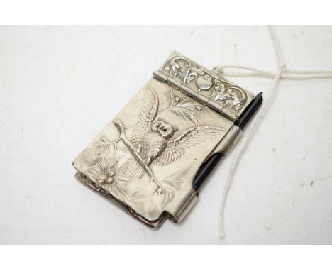 An Art Nouveau white metal note case, of small proportions, the hinged cover with embossed owl and foliage, with pencil holde