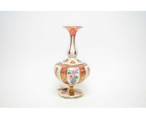 A 19th Century Bohemian ruby glass art vase, of double baluster form, with an everted rim and flared foot, richly enamelled a