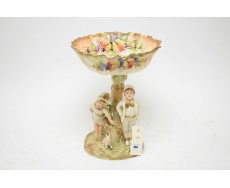 A Nautilus Porcelain pedestal dish, raised on a tree trunk support, over a circular base with figural boy, girl and rabbit, 2
