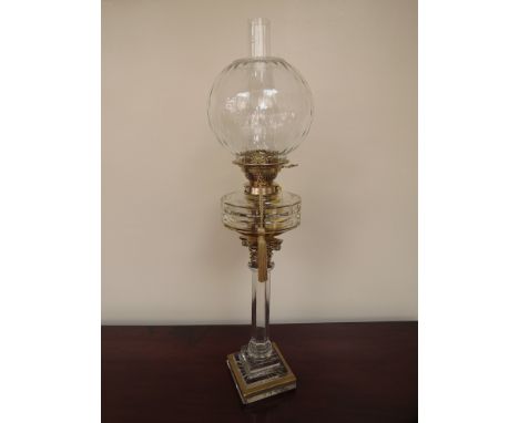 A Victorian circa 1870 lead crystal oil lamp by Messenger with a gilded brass Corinthian capital, with lead crystal optic sha