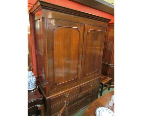 An 18th century oak linen press the two doors opening to reveal hooks and hanging rail over two short and two long drawers on
