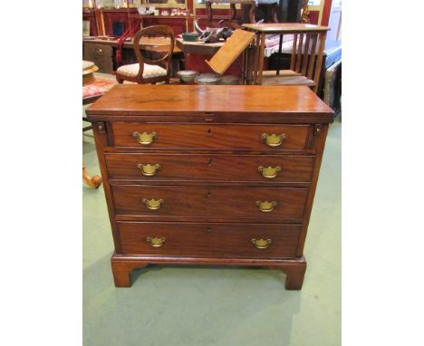 An early George III revival mahogany bachelor's chest the fold over hinged top over pull out slides and four long drawers on 