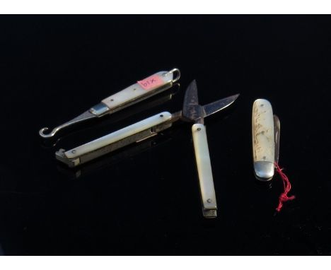 Sewing items including a pair of Singer sewing machine folding scissors, a mother of pearl handled knife and button hook with