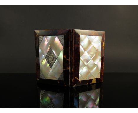 A mother of pearl and tortoiseshell card case with engraved silver panels, blue waterfall silk compartmental interior 
