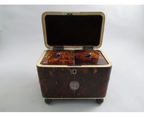 A 19th Century tortoiseshell and ivory tea caddy with monogrammed cartouche and lock (no key) on ball feet, 18 x 18cm     